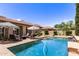 Beautiful backyard pool area with patio seating, umbrellas, and well-maintained landscaping at 3441 S Halsted Pl, Chandler, AZ 85286