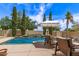Backyard pool with waterfall feature, lounge chairs, well-maintained landscaping and nearby patio at 3441 S Halsted Pl, Chandler, AZ 85286