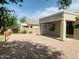 A covered patio with a gravel yard and lush greenery create a relaxing outdoor space at 3555 E Feather Ave, Gilbert, AZ 85234