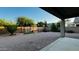 Spacious backyard featuring desert landscaping, stone pavers, and a covered patio at 3555 E Feather Ave, Gilbert, AZ 85234