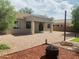 A beautiful backyard has a covered patio with gravel and desert landscaping at 3555 E Feather Ave, Gilbert, AZ 85234