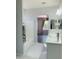 Modern bathroom featuring a glass bowl sink, tub, and gray wood flooring in the adjoining room at 3555 E Feather Ave, Gilbert, AZ 85234