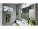 Modern bathroom featuring a stylish glass vessel sink, neutral paint and a decorative mirror at 3555 E Feather Ave, Gilbert, AZ 85234