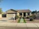 Charming single story home featuring a manicured front yard, desert landscaping and a two car garage at 3555 E Feather Ave, Gilbert, AZ 85234