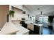 Bright kitchen featuring white cabinets, quartz countertops, modern appliances, an island and wood flooring at 3555 E Feather Ave, Gilbert, AZ 85234