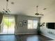 Open living area with sliding doors, modern ceiling fan, luxury vinyl flooring and backyard views at 3555 E Feather Ave, Gilbert, AZ 85234