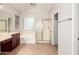 Bright bathroom featuring a vanity, bathtub, and shower with glass doors, complemented by tile floors at 3750 S Ashley Pl, Chandler, AZ 85286