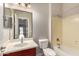 Bathroom featuring a vanity with cherry cabinets, a mirror, and a shower-tub combo at 3750 S Ashley Pl, Chandler, AZ 85286