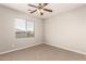 A bedroom with carpet, a ceiling fan, and a window with blinds at 3750 S Ashley Pl, Chandler, AZ 85286