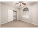 Bedroom featuring a ceiling fan, closet with sliding doors, and decorative window providing a cozy retreat at 3750 S Ashley Pl, Chandler, AZ 85286