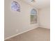 Neutral bedroom featuring carpet floors and a distinctive arched window at 3750 S Ashley Pl, Chandler, AZ 85286