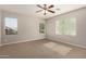 Light filled bedroom with neutral carpet and paint, with large windows providing natural lighting and backyard view at 3750 S Ashley Pl, Chandler, AZ 85286
