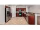 Well-equipped kitchen with stainless steel appliances, granite countertops, and dark wood cabinetry at 3750 S Ashley Pl, Chandler, AZ 85286