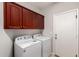 Laundry room with washer, dryer, and dark wood cabinetry at 3750 S Ashley Pl, Chandler, AZ 85286