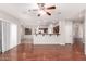 Open-concept living room showcasing hardwood floors, ceiling fan, and a view into the kitchen at 3750 S Ashley Pl, Chandler, AZ 85286