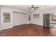 Spacious living room featuring hardwood floors, large windows, and sliding glass door at 3750 S Ashley Pl, Chandler, AZ 85286