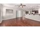 Open-concept living room with wood floors, access to the kitchen, and lots of natural light at 3750 S Ashley Pl, Chandler, AZ 85286