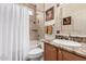 Bathroom featuring tile surround, a shower over tub, granite countertop and decorative framed art at 3930 E Colonial Dr, Chandler, AZ 85249