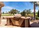 Outdoor kitchen area with a built in grill and views of the desert landscape at 3930 E Colonial Dr, Chandler, AZ 85249