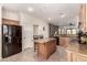 Modern kitchen featuring an island, ample cabinet space, stainless steel appliances, and a view into the living room at 3930 E Colonial Dr, Chandler, AZ 85249