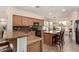 Well-appointed kitchen with modern appliances, an island with bar stool seating, and an adjacent dining area at 3930 E Colonial Dr, Chandler, AZ 85249