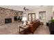 Inviting living room showcasing a stone fireplace, comfortable seating, and sliding doors to the outdoor space at 3930 E Colonial Dr, Chandler, AZ 85249