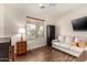 Comfortable living room with wood-look tile flooring, and plenty of natural light at 3930 E Colonial Dr, Chandler, AZ 85249