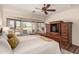 Inviting main bedroom featuring a large bay window, a ceiling fan, and a built-in dresser at 3930 E Colonial Dr, Chandler, AZ 85249