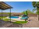 Beautiful backyard oasis with lush green grass, sparkling pool and lounge chairs at 3960 W Salter Dr, Glendale, AZ 85308