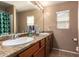 Spacious bathroom with a double sink vanity, large mirror, and shower/tub combination with stylish curtain at 3960 W Salter Dr, Glendale, AZ 85308
