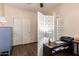 Bedroom features laminate floors, a room divider and a work area with a dark brown desk at 3960 W Salter Dr, Glendale, AZ 85308