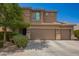 The exterior of the two-story home has a three-car garage, neutral color scheme, and well-manicured landscaping at 3960 W Salter Dr, Glendale, AZ 85308