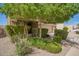 The front yard is beautifully landscaped with lush greenery and mature trees that provide shade and privacy at 3960 W Salter Dr, Glendale, AZ 85308