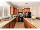 Bright kitchen featuring granite countertops, wood cabinets, and stainless steel appliances at 3960 W Salter Dr, Glendale, AZ 85308