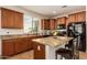 Inviting kitchen featuring granite countertops, wood cabinets, and modern black appliances at 3960 W Salter Dr, Glendale, AZ 85308