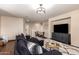 Open-concept living room with modern decor, dark sofa, stylish rug, and a TV at 3960 W Salter Dr, Glendale, AZ 85308