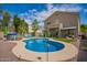 Backyard pool features a baja step and inground hot tub with lounge seating, plus a covered patio off the main house at 3960 W Salter Dr, Glendale, AZ 85308
