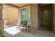 Inviting front porch with neutral exterior, comfortable seating, and a decorative door at 3960 W Salter Dr, Glendale, AZ 85308