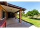 Inviting covered patio overlooking a well-maintained backyard with mature trees, perfect for outdoor enjoyment at 4420 E Covina St, Mesa, AZ 85205