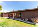 View of backyard featuring a shed, green grass, and covered patio, creating a relaxing outdoor space at 4420 E Covina St, Mesa, AZ 85205