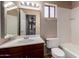 Well-lit bathroom featuring white tile, a tub, and a sink vanity at 4420 E Covina St, Mesa, AZ 85205