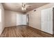 Spacious bedroom with ceiling fan, wood floors, and ample closet space at 4420 E Covina St, Mesa, AZ 85205