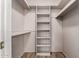 Walk-in closet with built-in shelving, perfect for organization and storage at 4420 E Covina St, Mesa, AZ 85205