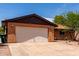 Close up of the attached single car garage and drought resistant landscaping at 4420 E Covina St, Mesa, AZ 85205