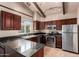 Modern kitchen featuring stainless steel appliances and granite countertops at 4420 E Covina St, Mesa, AZ 85205