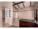 Open floor plan with vaulted ceilings, beams, and neutral tile flooring at 4420 E Covina St, Mesa, AZ 85205