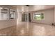 Bright living room with tile floors, windows, and sliding glass door at 4420 E Covina St, Mesa, AZ 85205