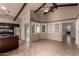 Cozy living room with beamed ceilings and view to kitchen at 4420 E Covina St, Mesa, AZ 85205