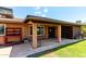 Covered patio area with brick columns, providing a comfortable outdoor living space and backyard view at 4420 E Covina St, Mesa, AZ 85205