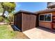 Exterior view of shed next to brick house, offering additional storage on property at 4420 E Covina St, Mesa, AZ 85205